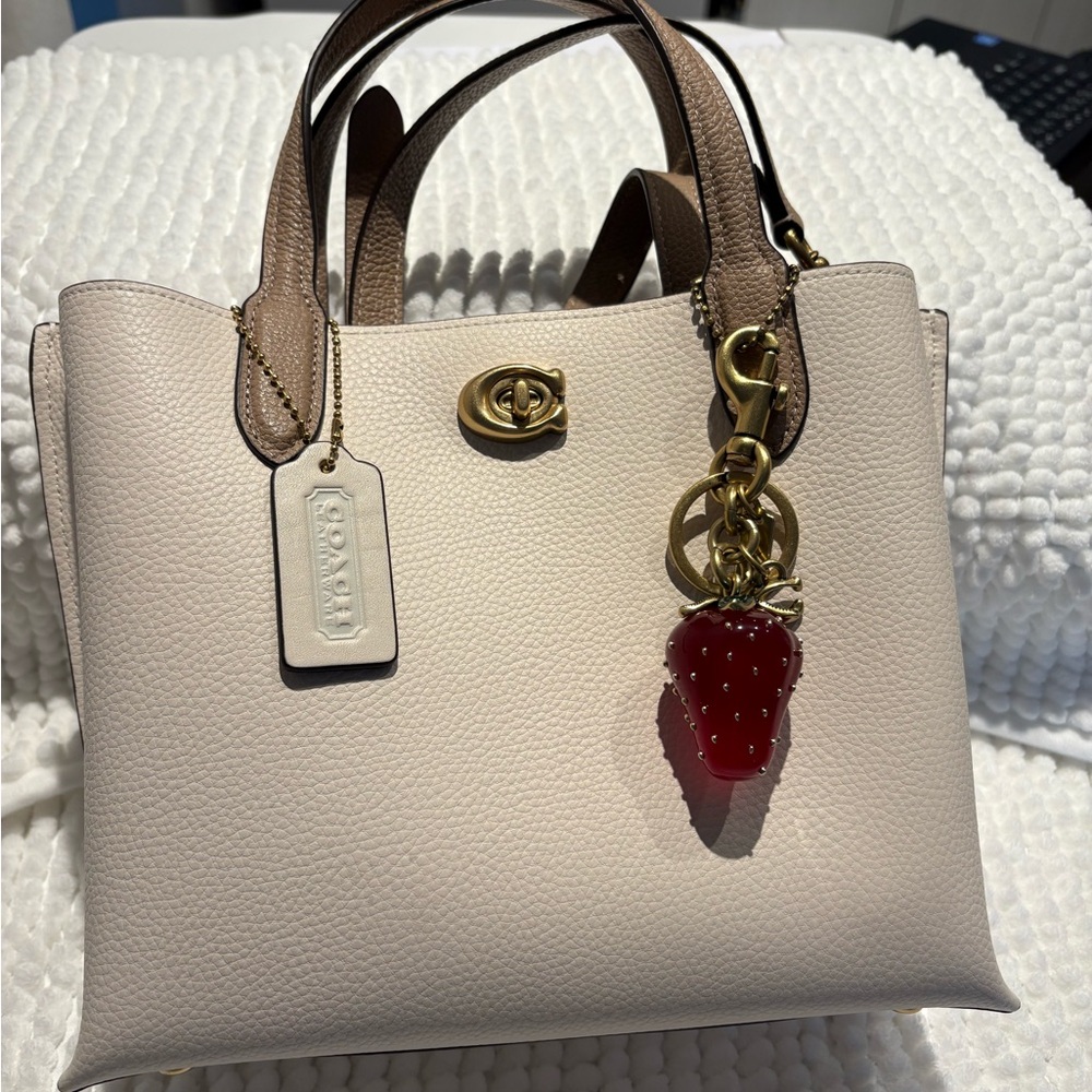 Coach Cream and Brown Satchel with Gold-Tone Hardware. Charms are not included.